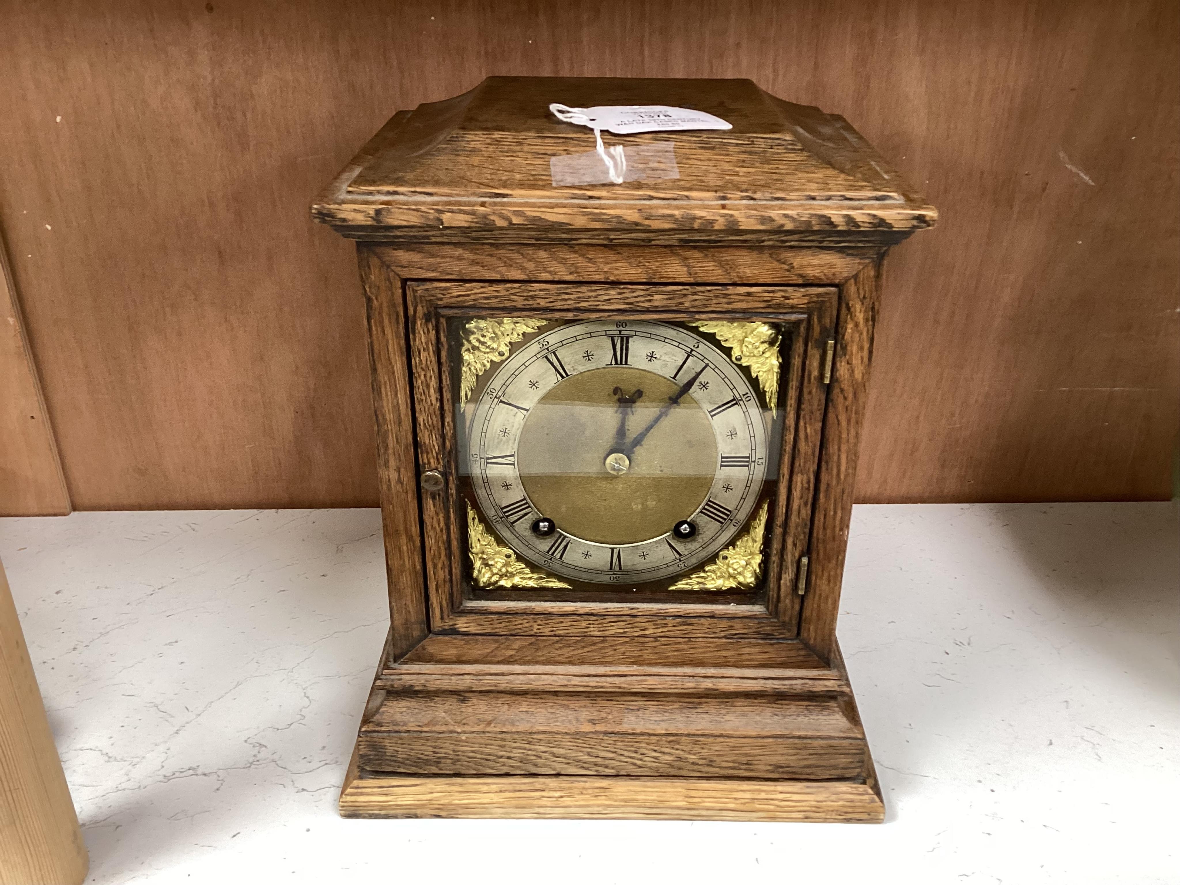 A late 19th century W&H oak cased mantel clock, chiming and striking on two coiled gongs, 27cm high. Condition - fair to good, missing the handle to the top